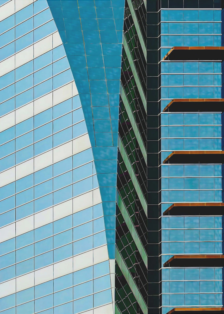 An abstract close-up photograph of modern skyscrapers, featuring a dynamic composition of intersecting lines and geometric patterns. The facades consist of blue, white, and dark green reflective glass, creating a visually complex play of light, shadow, and color. Wall Art