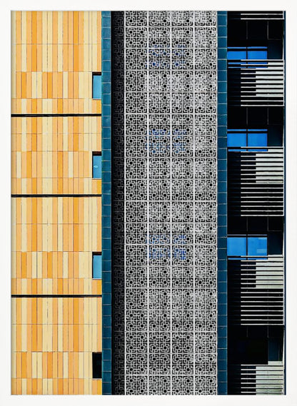 A vertical abstract architectural photograph showcasing the facade of a modern building, featuring a contrast of textures and colors: warm yellow vertical tiles on the left, an intricate white geometric screen in the center, and a dark section with vibrant blue windows on the right. Print