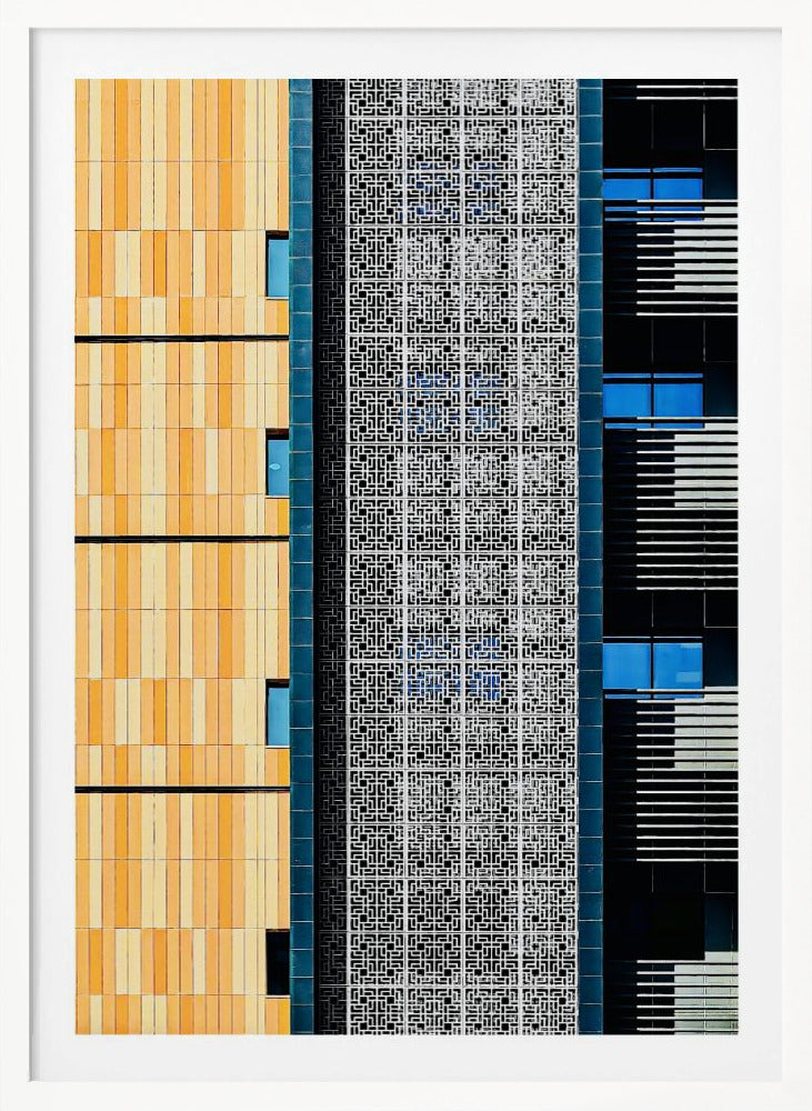 A vertical abstract architectural photograph showcasing the facade of a modern building, featuring a contrast of textures and colors: warm yellow vertical tiles on the left, an intricate white geometric screen in the center, and a dark section with vibrant blue windows on the right. Print