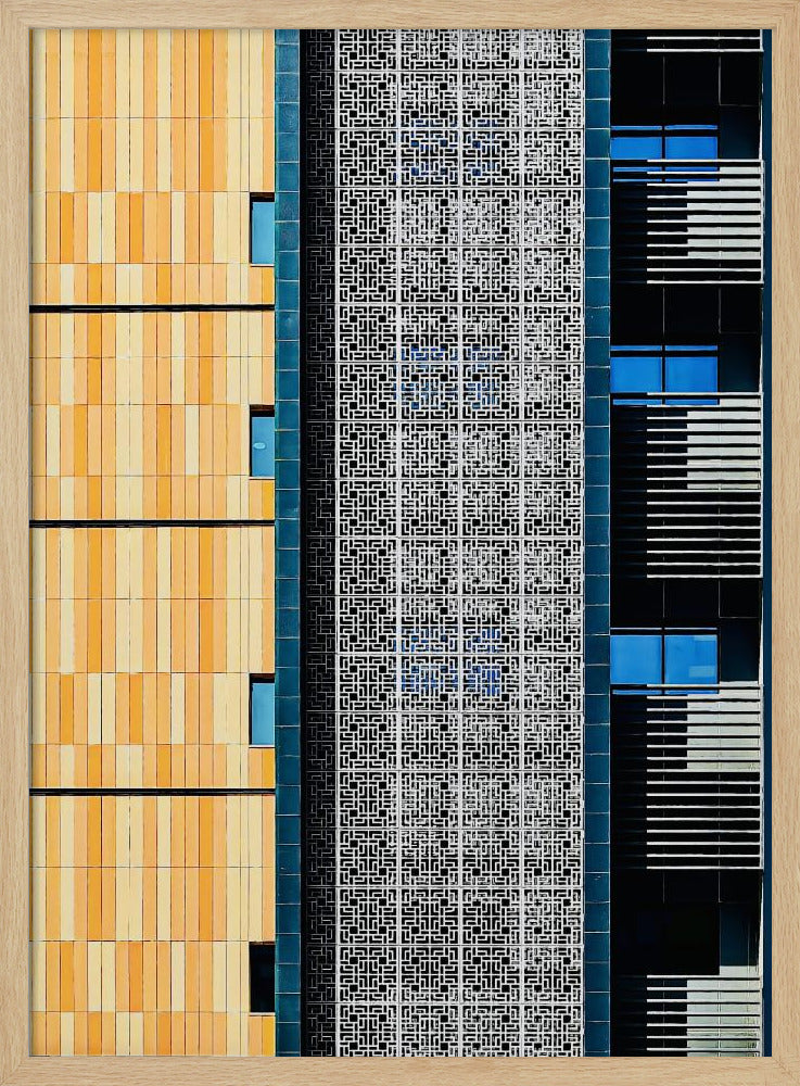 A vertical abstract architectural photograph showcasing the facade of a modern building, featuring a contrast of textures and colors: warm yellow vertical tiles on the left, an intricate white geometric screen in the center, and a dark section with vibrant blue windows on the right. Print