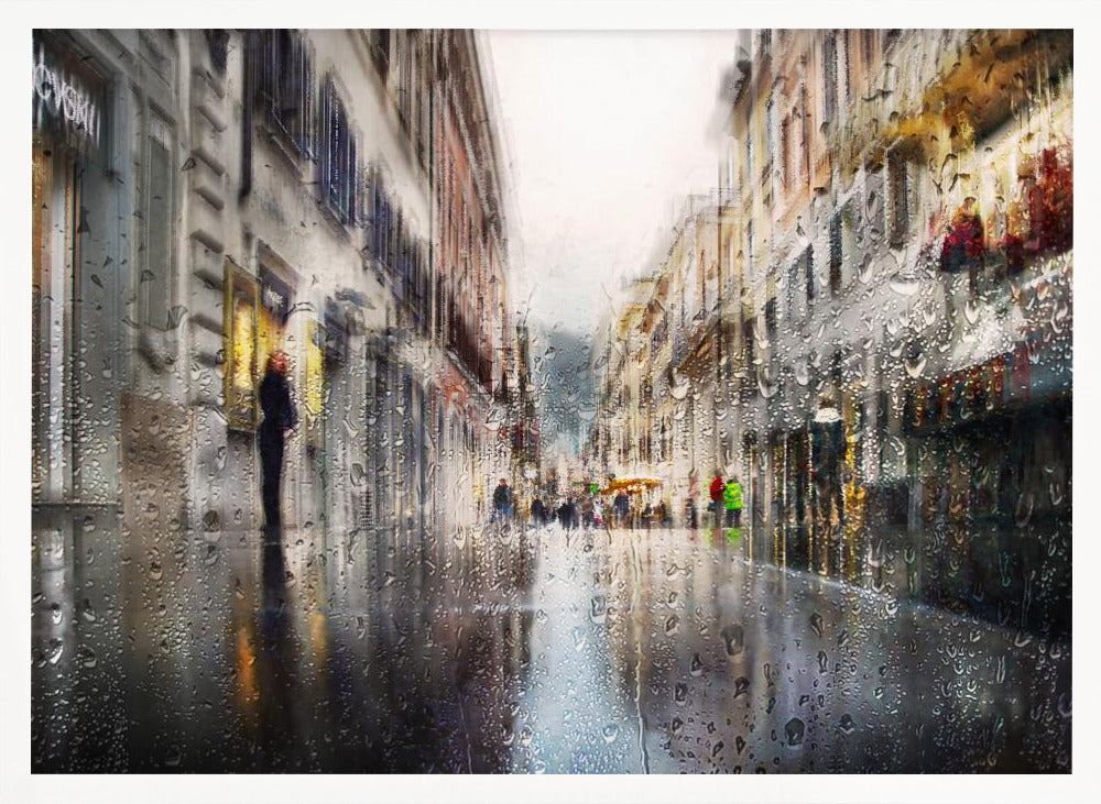 An impressionistic painting of a city street on a rainy day, viewed as if through a window covered in water droplets. The scene is blurred and atmospheric, with the wet pavement reflecting the muted colors of the buildings and distant figures. The artwork is presented in a silver frame. Decor