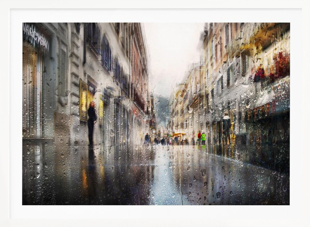 An impressionistic painting of a city street on a rainy day, viewed as if through a window covered in water droplets. The scene is blurred and atmospheric, with the wet pavement reflecting the muted colors of the buildings and distant figures. The artwork is presented in a silver frame. Decor