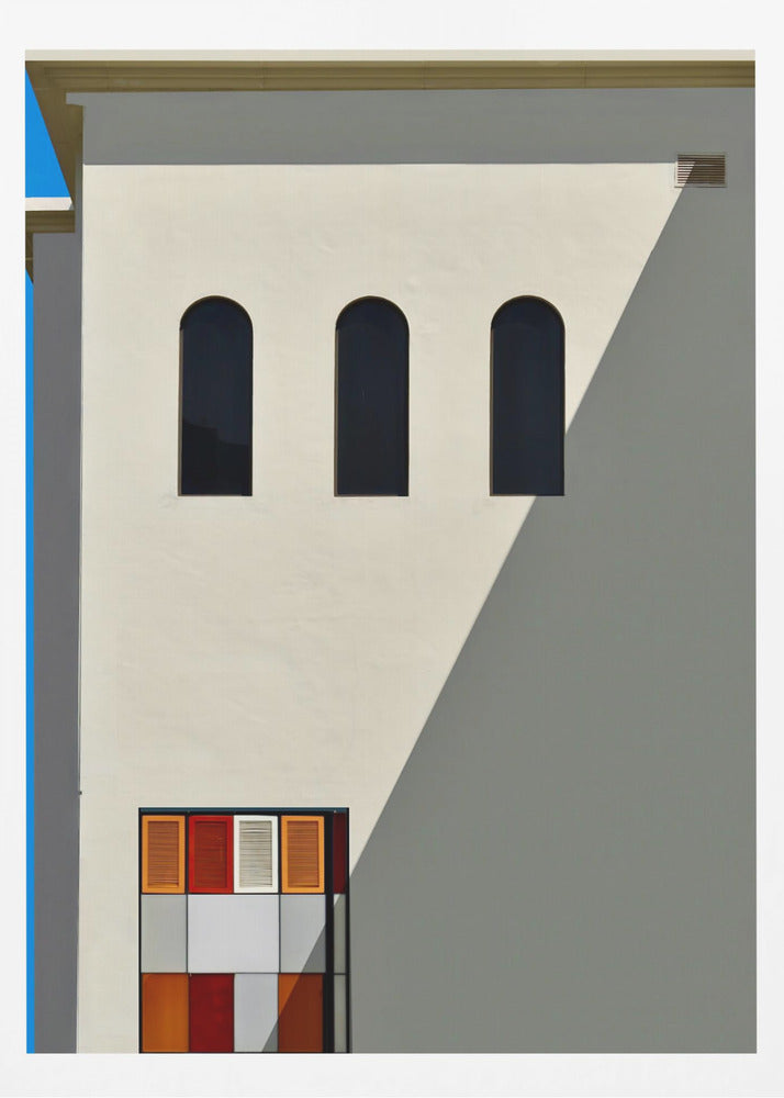 A minimalist photograph of a cream-colored building facade with a sharp diagonal shadow. Three black arched windows are arranged horizontally, and below them, a colorful grid of red, orange, and white panels. A vibrant blue vertical stripe is visible on the far left edge. Wall Art