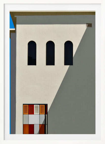 A minimalist photograph of a cream-colored building facade with a sharp diagonal shadow. Three black arched windows are arranged horizontally, and below them, a colorful grid of red, orange, and white panels. A vibrant blue vertical stripe is visible on the far left edge. Wall Art