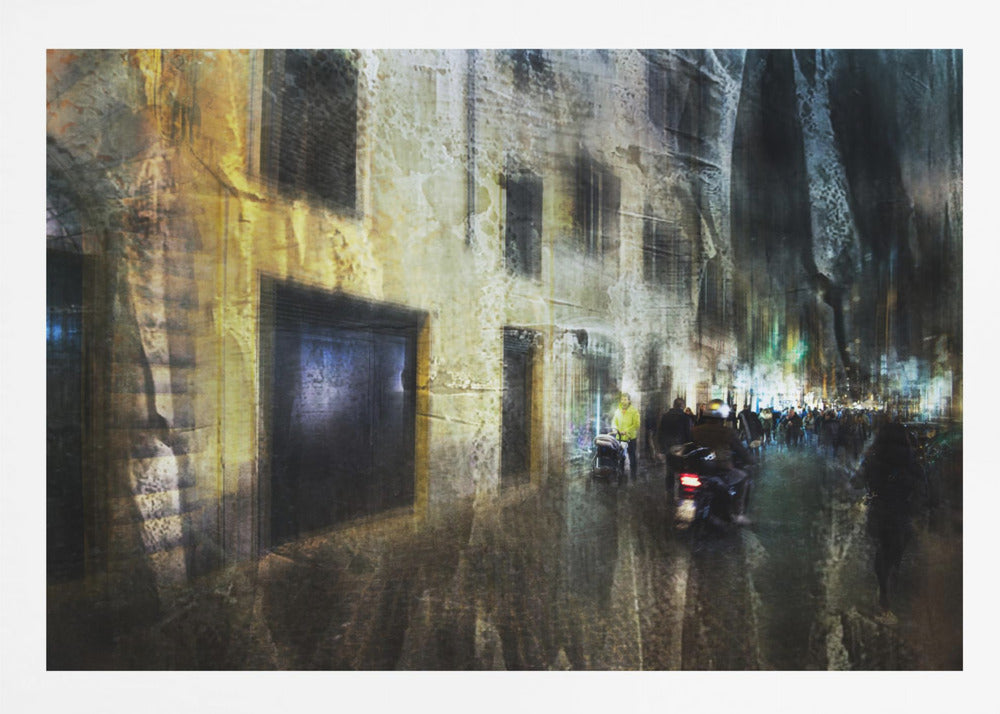 A framed abstract digital artwork depicting a busy, narrow city street at night. The image has a heavily textured, painterly style, with blurred motion effects. A weathered, yellow-lit building is on the left, while the street on the right is filled with indistinct figures of people and a motorcycle, with city lights glowing in the distance. Wall Art