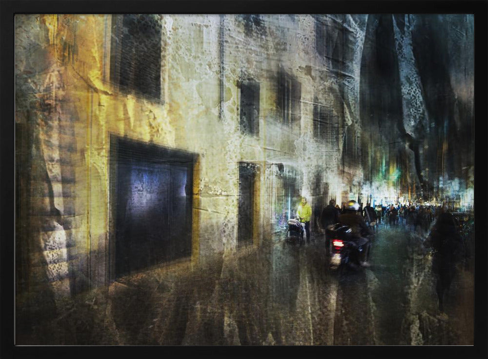 A framed abstract digital artwork depicting a busy, narrow city street at night. The image has a heavily textured, painterly style, with blurred motion effects. A weathered, yellow-lit building is on the left, while the street on the right is filled with indistinct figures of people and a motorcycle, with city lights glowing in the distance. Wall Art