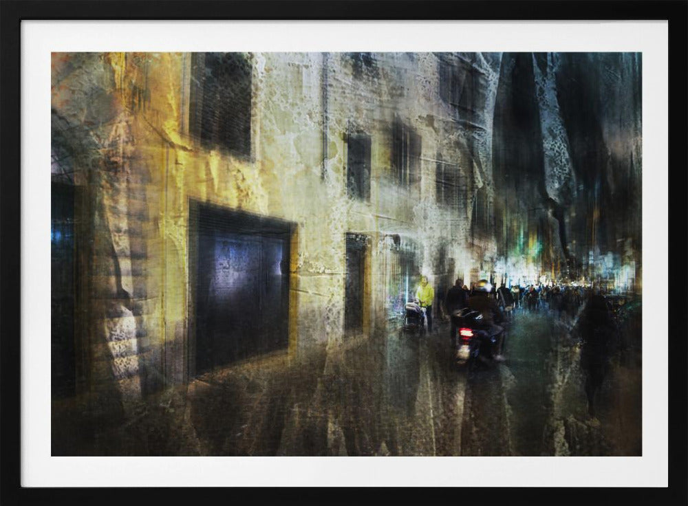 A framed abstract digital artwork depicting a busy, narrow city street at night. The image has a heavily textured, painterly style, with blurred motion effects. A weathered, yellow-lit building is on the left, while the street on the right is filled with indistinct figures of people and a motorcycle, with city lights glowing in the distance. Wall Art