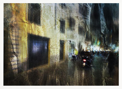 A framed abstract digital artwork depicting a busy, narrow city street at night. The image has a heavily textured, painterly style, with blurred motion effects. A weathered, yellow-lit building is on the left, while the street on the right is filled with indistinct figures of people and a motorcycle, with city lights glowing in the distance. Wall Art