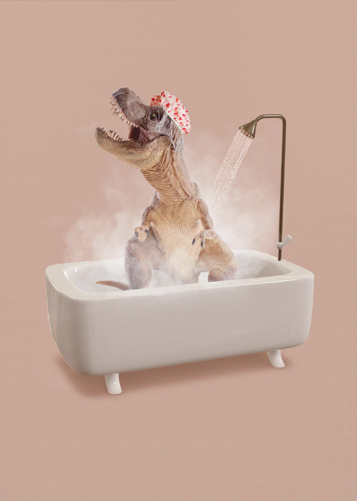 A humorous image of a Tyrannosaurus Rex wearing a red and white shower cap while taking a shower in a small white bathtub. The dinosaur has its head tilted back with its mouth open, enjoying the water, and is surrounded by steam against a dusty pink background. Print