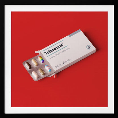 A framed conceptual art piece on a bright red background. It features a white medicine box labeled 'Tolerance', with a blister pack of pills emerging. Most pills are in various skin tones, but one is a rainbow pride flag and another is a transgender pride flag. Artwork