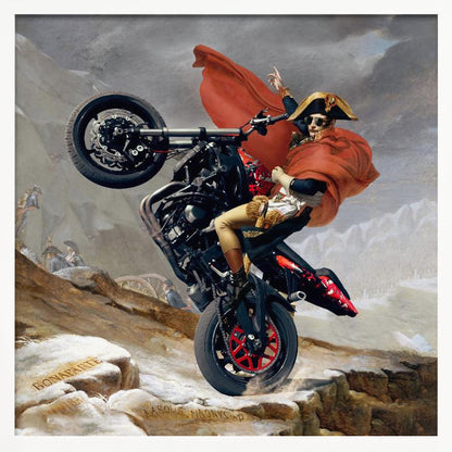 A framed parody artwork of the classic painting 'Napoleon Crossing the Alps.' Instead of a horse, Napoleon Bonaparte is performing a dramatic wheelie on a modern black and red motorcycle. He wears sunglasses, his signature bicorne hat, and a flowing red cape against a snowy, mountainous backdrop. Print