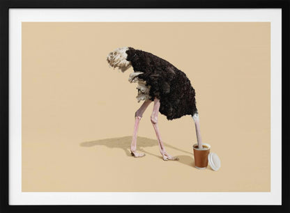 A humorous and surreal image of a black and white ostrich with its head buried inside a disposable coffee cup, set against a plain beige background and enclosed in a silver frame. Decor
