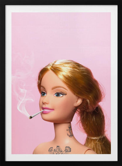 A close-up photograph of a blonde doll, resembling Barbie, with tattoos on her neck and chest, smoking a joint against a solid pink background. Smoke curls upwards from the lit cigarette in her pink-lipsticked mouth. Artwork