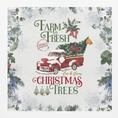 A vintage-style Christmas art print in a light wood frame. It features a watercolor illustration of a classic red pickup truck carrying a Christmas tree, with snow on its hood and roof. The text reads 'Farm Fresh Cut & Carry Christmas Trees' in festive green and red fonts. The background is white with a decorative border of frosted greenery and snowflakes. Wall Art