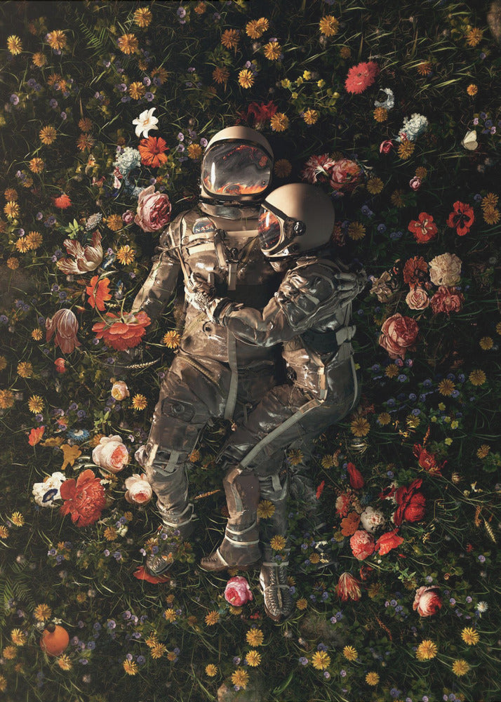 An overhead view of two astronauts in full gear, embracing each other while lying down in a lush, dark field filled with a vibrant array of colorful flowers. Wall Art