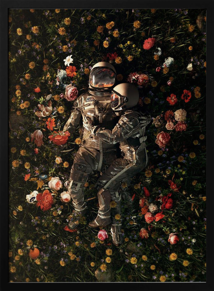 An overhead view of two astronauts in full gear, embracing each other while lying down in a lush, dark field filled with a vibrant array of colorful flowers. Wall Art