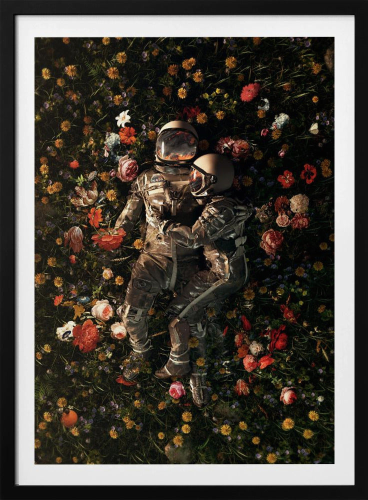 An overhead view of two astronauts in full gear, embracing each other while lying down in a lush, dark field filled with a vibrant array of colorful flowers. Wall Art