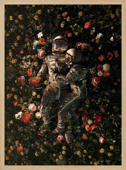 An overhead view of two astronauts in full gear, embracing each other while lying down in a lush, dark field filled with a vibrant array of colorful flowers. Wall Art