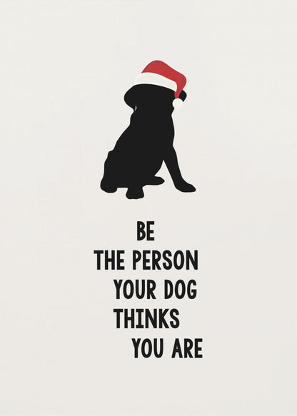A framed art print featuring a black silhouette of a dog wearing a red Santa hat on an off-white background. Below the dog is the motivational quote, 'BE THE PERSON YOUR DOG THINKS YOU ARE' in black block letters. Decor