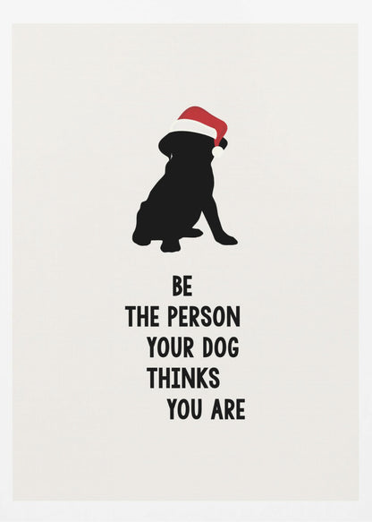 A framed art print featuring a black silhouette of a dog wearing a red Santa hat on an off-white background. Below the dog is the motivational quote, 'BE THE PERSON YOUR DOG THINKS YOU ARE' in black block letters. Decor