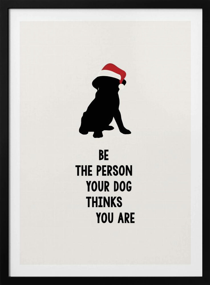 A framed art print featuring a black silhouette of a dog wearing a red Santa hat on an off-white background. Below the dog is the motivational quote, 'BE THE PERSON YOUR DOG THINKS YOU ARE' in black block letters. Decor