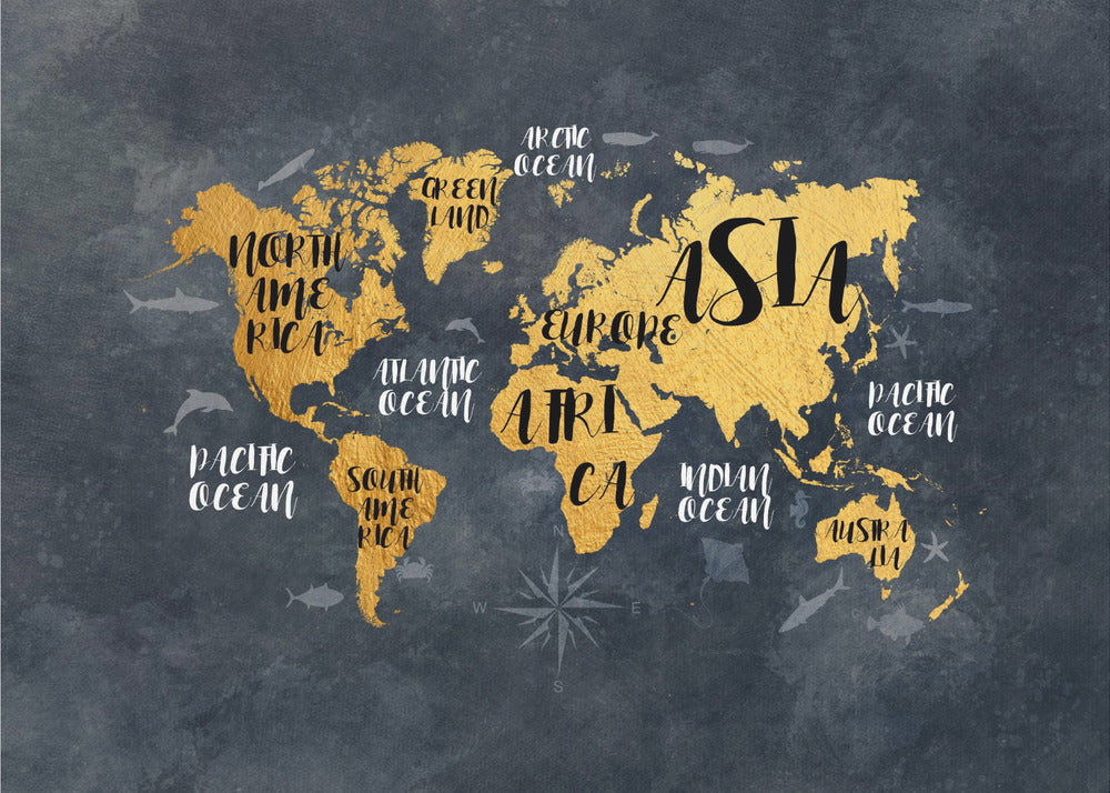 A modern world map artwork with gold leaf continents set against a textured dark gray background. Continents and oceans are labeled with decorative typography, and subtle illustrations of sea life swim in the oceans. The art is presented in a silver frame. Artwork