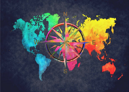 An artistic world map in a silver frame, featuring continents in a vibrant rainbow watercolor style against a dark, textured navy blue background. A large, ornate, and colorful compass rose is superimposed in the center of the map. Artwork
