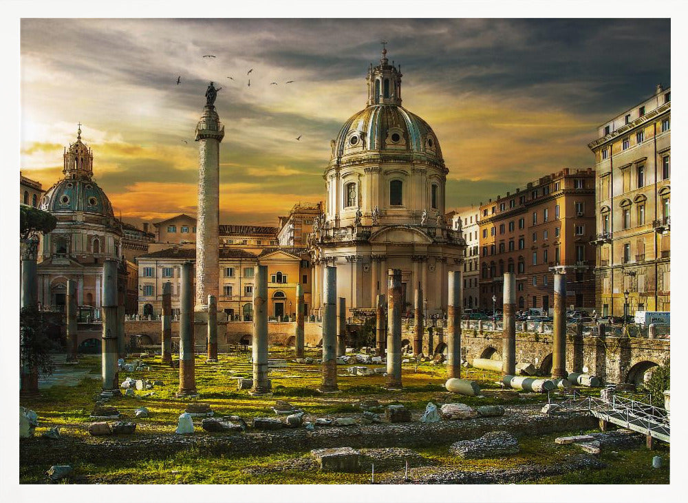 A framed photograph of Trajan's Forum in Rome, Italy, during a dramatic sunset. The foreground is filled with ancient stone columns and ruins on a grassy field, leading to the prominent Trajan's Column and the domed Church of the Most Holy Name of Mary against a golden and dark cloudy sky. Wall Art