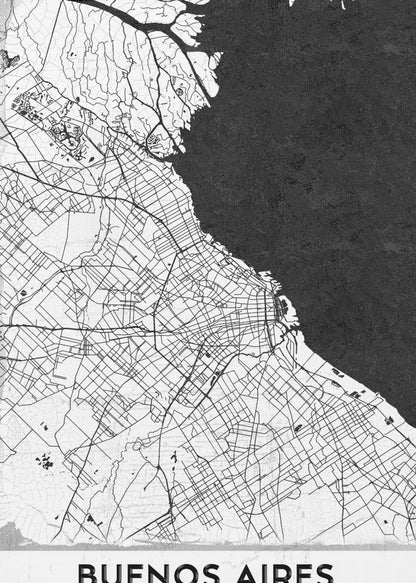 A minimalist black and white map of Buenos Aires, presented as a poster in a black frame. The city's roads and geography are detailed in black lines on a white background, while the adjacent body of water is solid black. The text 'BUENOS AIRES' is displayed at the bottom. Wall Art