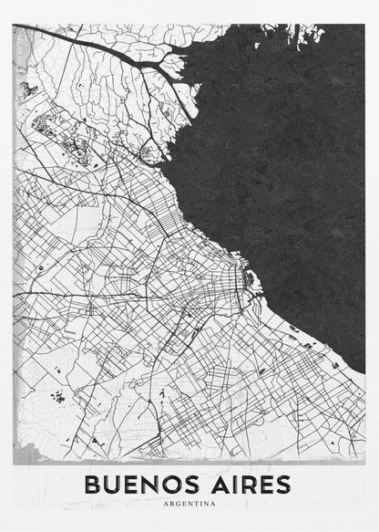 A minimalist black and white map of Buenos Aires, presented as a poster in a black frame. The city's roads and geography are detailed in black lines on a white background, while the adjacent body of water is solid black. The text 'BUENOS AIRES' is displayed at the bottom. Wall Art