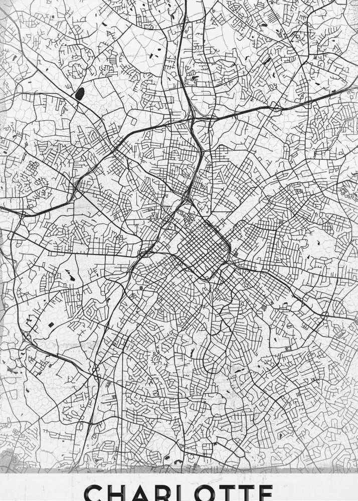 A minimalist black and white map of Charlotte, North Carolina, displayed in a black frame. The map details the intricate network of city streets and highways. At the bottom, a white banner features the city's name 'CHARLOTTE' in a bold, black, sans-serif font. Poster