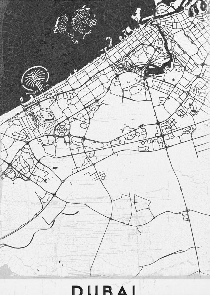 A minimalist black and white map of Dubai in a black frame. The water is depicted in black with a subtle texture, while the land is white, showing the city's road network in thin black lines. Key features like the Palm Jumeirah and The World Islands are visible off the coast. The word 'DUBAI' is written in a bold, black, sans-serif font at the bottom. Decor