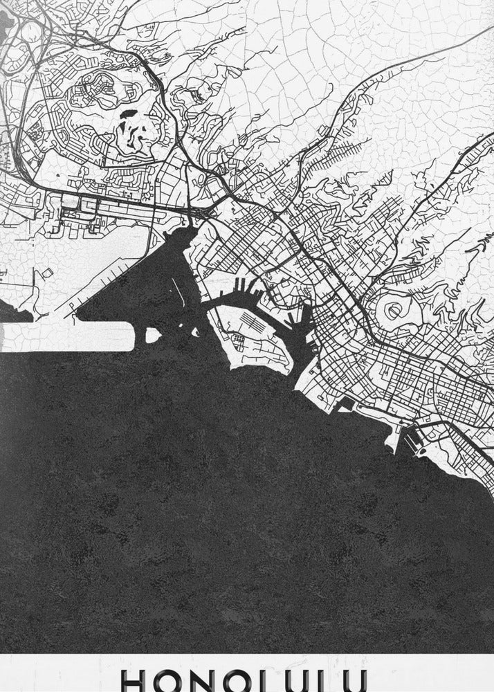 A framed, minimalist black and white map of Honolulu, Hawaii. The city's streets and coastline are rendered in black lines on a white background, while the ocean is a solid, textured black. The word 'HONOLULU' is printed in black sans-serif font at the bottom. Artwork
