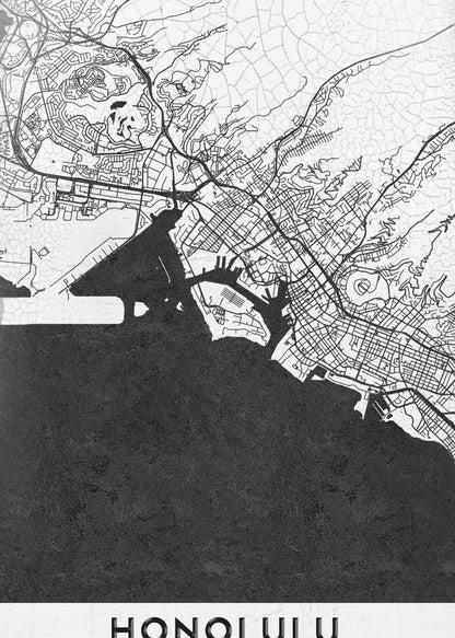 A framed, minimalist black and white map of Honolulu, Hawaii. The city's streets and coastline are rendered in black lines on a white background, while the ocean is a solid, textured black. The word 'HONOLULU' is printed in black sans-serif font at the bottom. Artwork