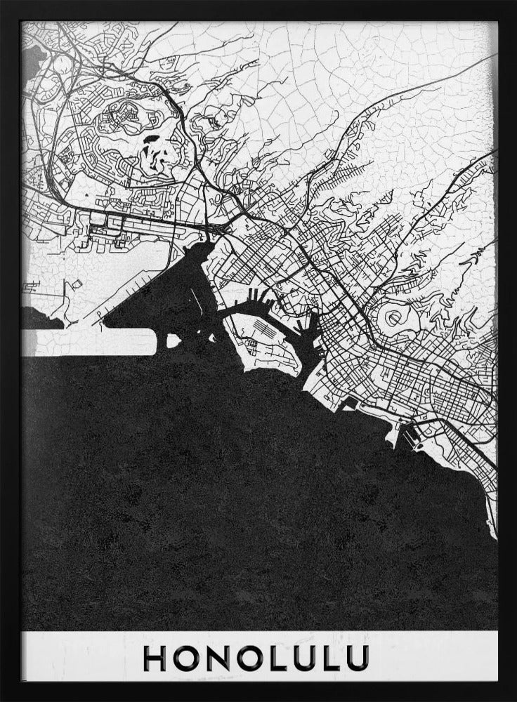 A framed, minimalist black and white map of Honolulu, Hawaii. The city's streets and coastline are rendered in black lines on a white background, while the ocean is a solid, textured black. The word 'HONOLULU' is printed in black sans-serif font at the bottom. Artwork