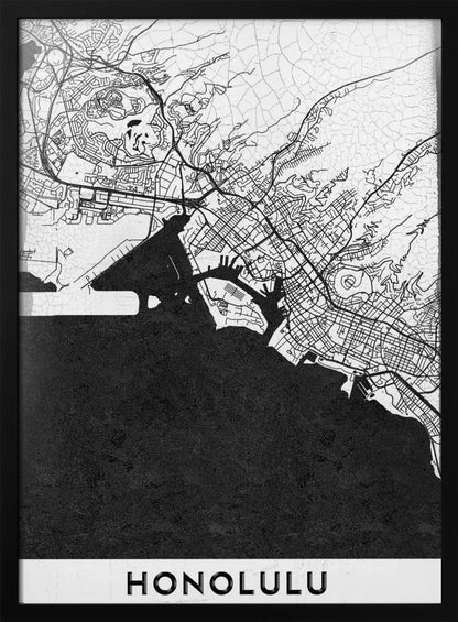 A framed, minimalist black and white map of Honolulu, Hawaii. The city's streets and coastline are rendered in black lines on a white background, while the ocean is a solid, textured black. The word 'HONOLULU' is printed in black sans-serif font at the bottom. Artwork