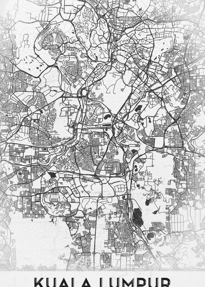 A minimalist black and white street map of Kuala Lumpur, displayed in a black frame. The map shows a detailed network of roads and city blocks on a textured white background. The name "KUALA LUMPUR" is printed in a bold, modern font at the bottom. Decor