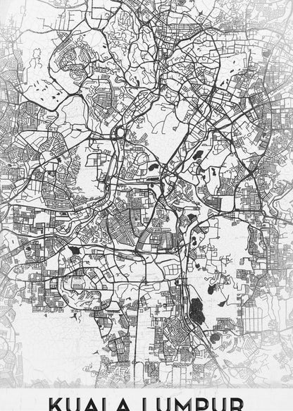 A minimalist black and white street map of Kuala Lumpur, displayed in a black frame. The map shows a detailed network of roads and city blocks on a textured white background. The name "KUALA LUMPUR" is printed in a bold, modern font at the bottom. Decor