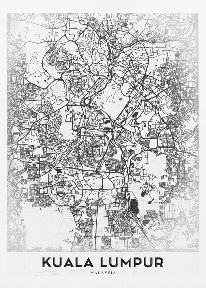 A minimalist black and white street map of Kuala Lumpur, displayed in a black frame. The map shows a detailed network of roads and city blocks on a textured white background. The name "KUALA LUMPUR" is printed in a bold, modern font at the bottom. Decor