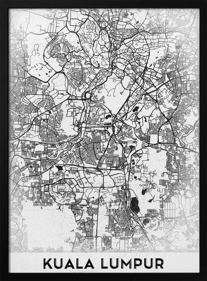 A minimalist black and white street map of Kuala Lumpur, displayed in a black frame. The map shows a detailed network of roads and city blocks on a textured white background. The name "KUALA LUMPUR" is printed in a bold, modern font at the bottom. Decor