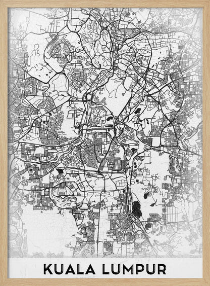 A minimalist black and white street map of Kuala Lumpur, displayed in a black frame. The map shows a detailed network of roads and city blocks on a textured white background. The name "KUALA LUMPUR" is printed in a bold, modern font at the bottom. Decor