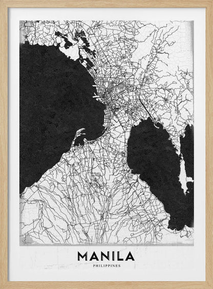 A minimalist black and white map of Manila, Philippines, presented in a black frame. The map showcases the city's intricate road network in black lines on a white landmass, contrasted against textured black bodies of water. The word 'MANILA' is printed in a bold, black sans-serif font at the bottom of the poster. Decor
