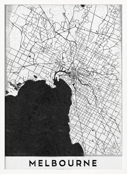 A minimalist black and white map of Melbourne, Australia, presented in a black frame. The city's road network is depicted with fine black lines on a textured white background, while the adjacent bay is shown in solid, textured black. The name 'MELBOURNE' is written in a bold, black font at the bottom. Poster