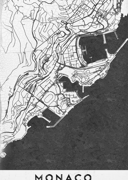 A modern black and white map of Monaco, presented as a framed poster. The map details the city's streets and coastline in black lines on a white background, while the sea is depicted in a solid, textured black. The title 'MONACO' is at the bottom in a bold, white band. Poster