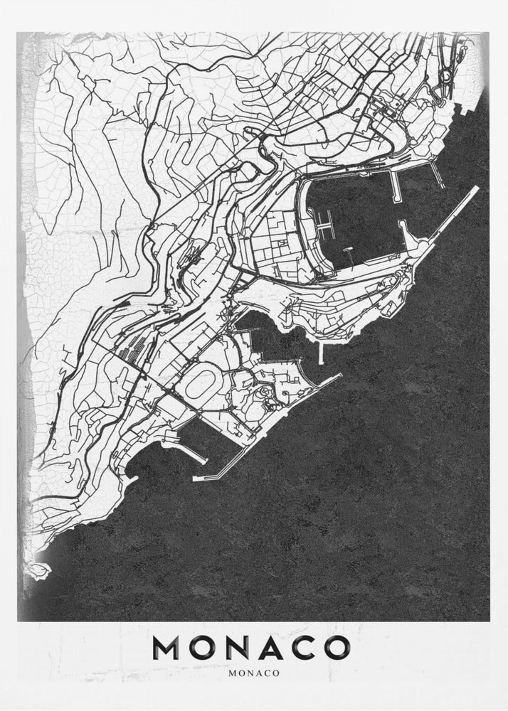 A modern black and white map of Monaco, presented as a framed poster. The map details the city's streets and coastline in black lines on a white background, while the sea is depicted in a solid, textured black. The title 'MONACO' is at the bottom in a bold, white band. Poster