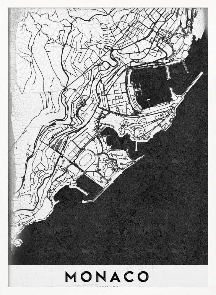 A modern black and white map of Monaco, presented as a framed poster. The map details the city's streets and coastline in black lines on a white background, while the sea is depicted in a solid, textured black. The title 'MONACO' is at the bottom in a bold, white band. Poster