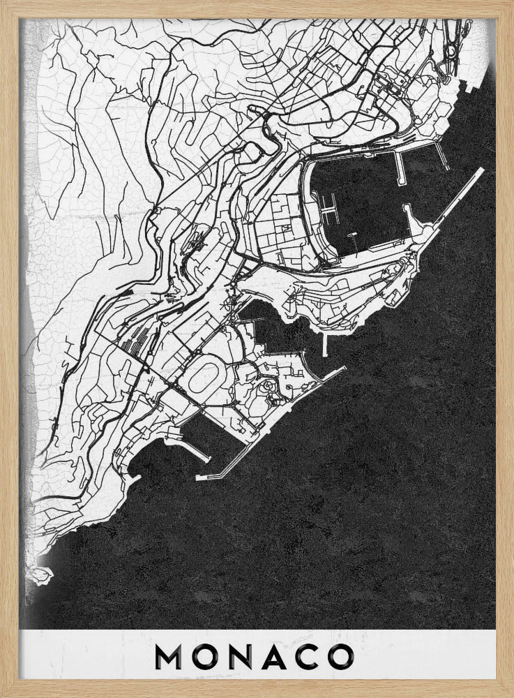A modern black and white map of Monaco, presented as a framed poster. The map details the city's streets and coastline in black lines on a white background, while the sea is depicted in a solid, textured black. The title 'MONACO' is at the bottom in a bold, white band. Poster