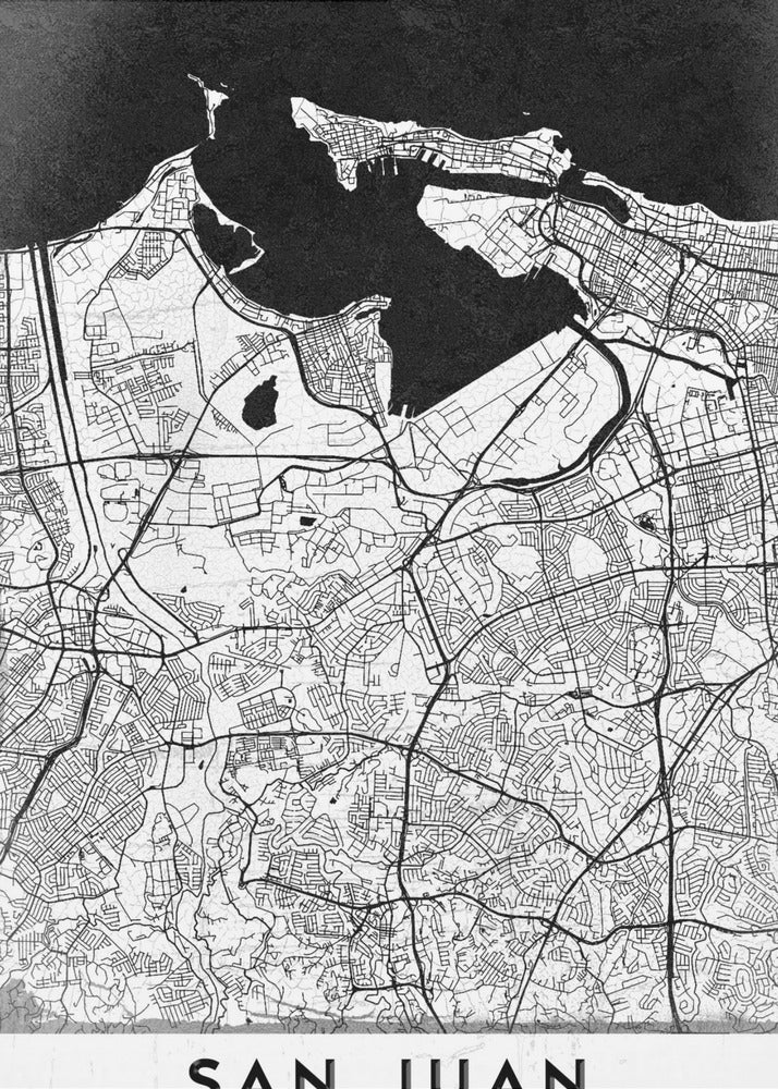 A minimalist black and white map of San Juan, Puerto Rico, shown as a framed poster. The land is depicted in white with intricate black lines for roads and streets, while the surrounding water is a solid, textured black. A white banner at the bottom features the text 'SAN JUAN' in a bold, black, sans-serif font. Artwork
