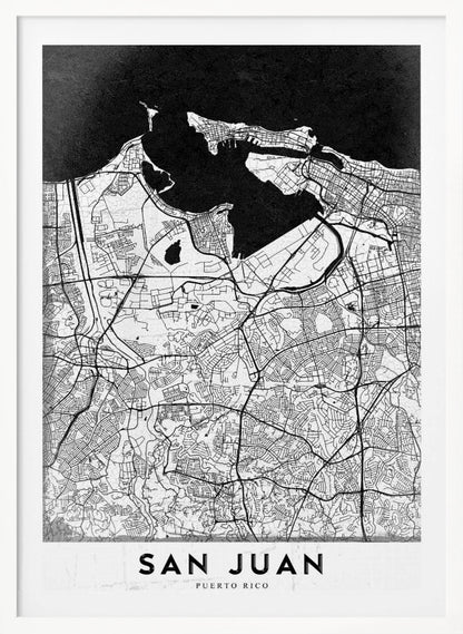 A minimalist black and white map of San Juan, Puerto Rico, shown as a framed poster. The land is depicted in white with intricate black lines for roads and streets, while the surrounding water is a solid, textured black. A white banner at the bottom features the text 'SAN JUAN' in a bold, black, sans-serif font. Artwork