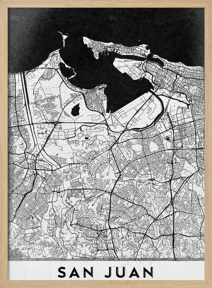 A minimalist black and white map of San Juan, Puerto Rico, shown as a framed poster. The land is depicted in white with intricate black lines for roads and streets, while the surrounding water is a solid, textured black. A white banner at the bottom features the text 'SAN JUAN' in a bold, black, sans-serif font. Artwork
